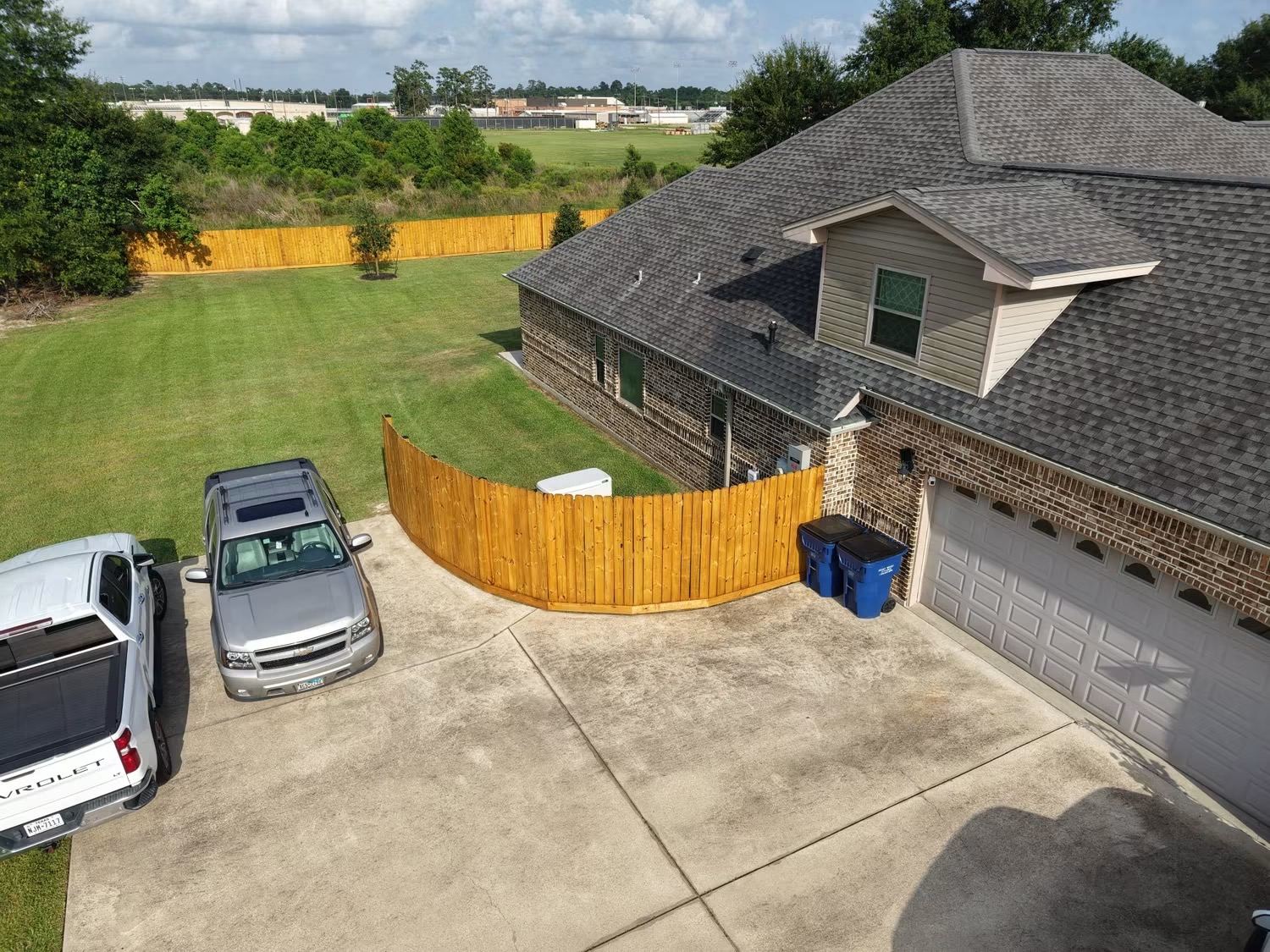 Wood privacy fence installation at a residential property