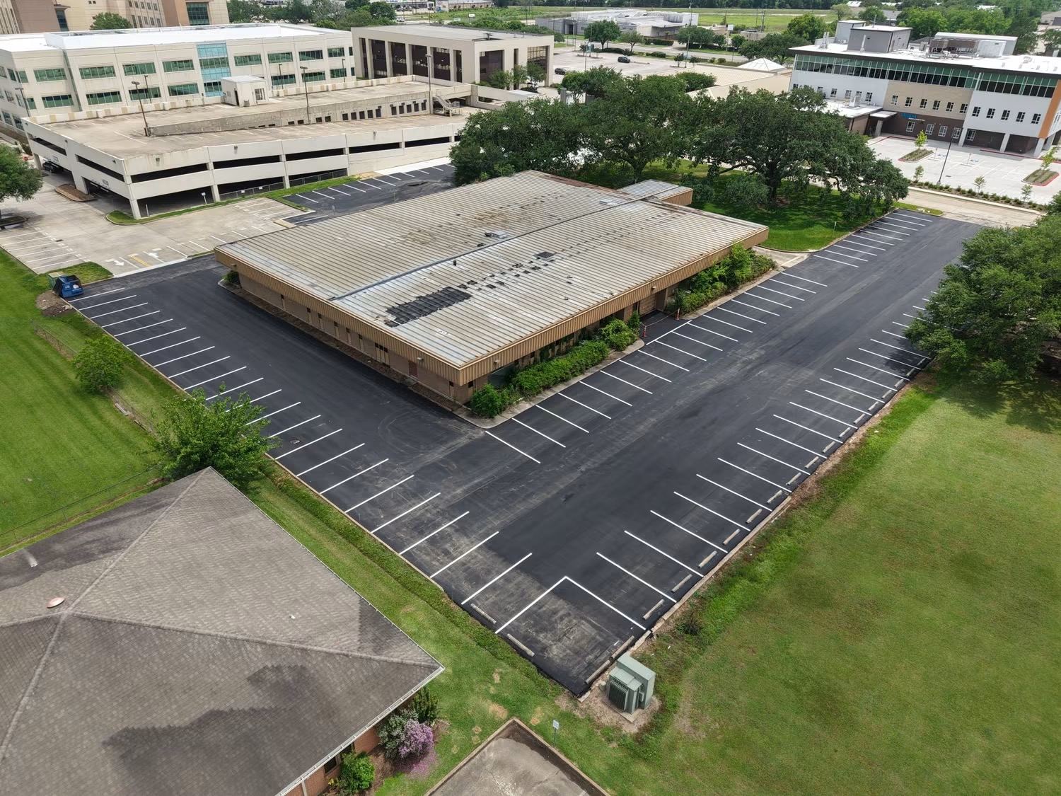Aerial view of a freshly striped commercial parking lot by GoldTex Industries